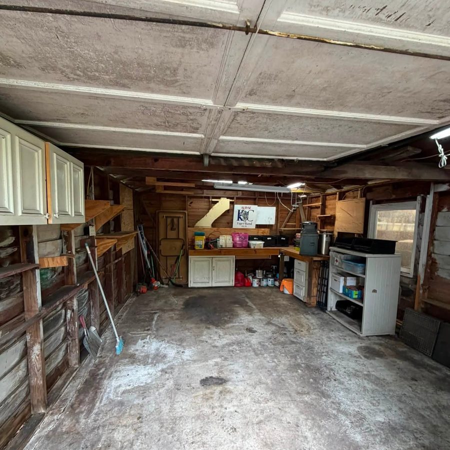 A garage cleared out with the floor swept down to the slab
